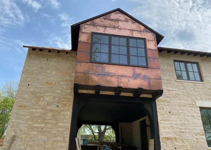 Copper metal panel facade on a stone building for Metal Roof Coating in Cody