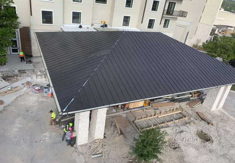 Metal roofing installation team working on a commercial building in Cody